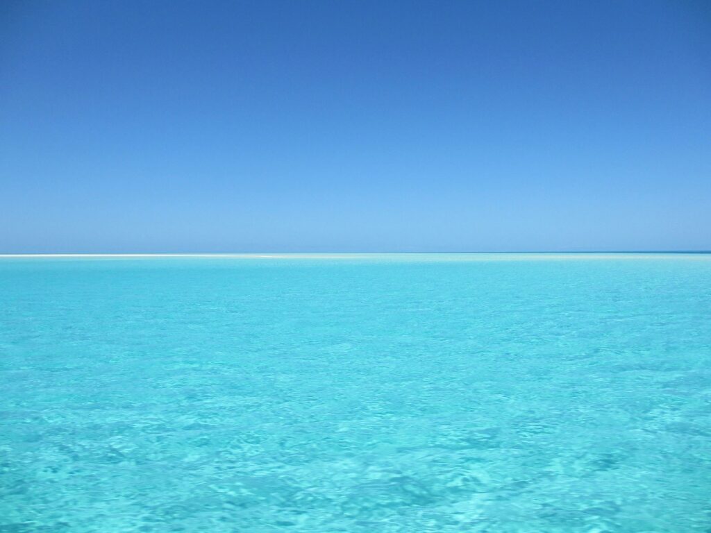 Clear turquoise sea under blue sky.